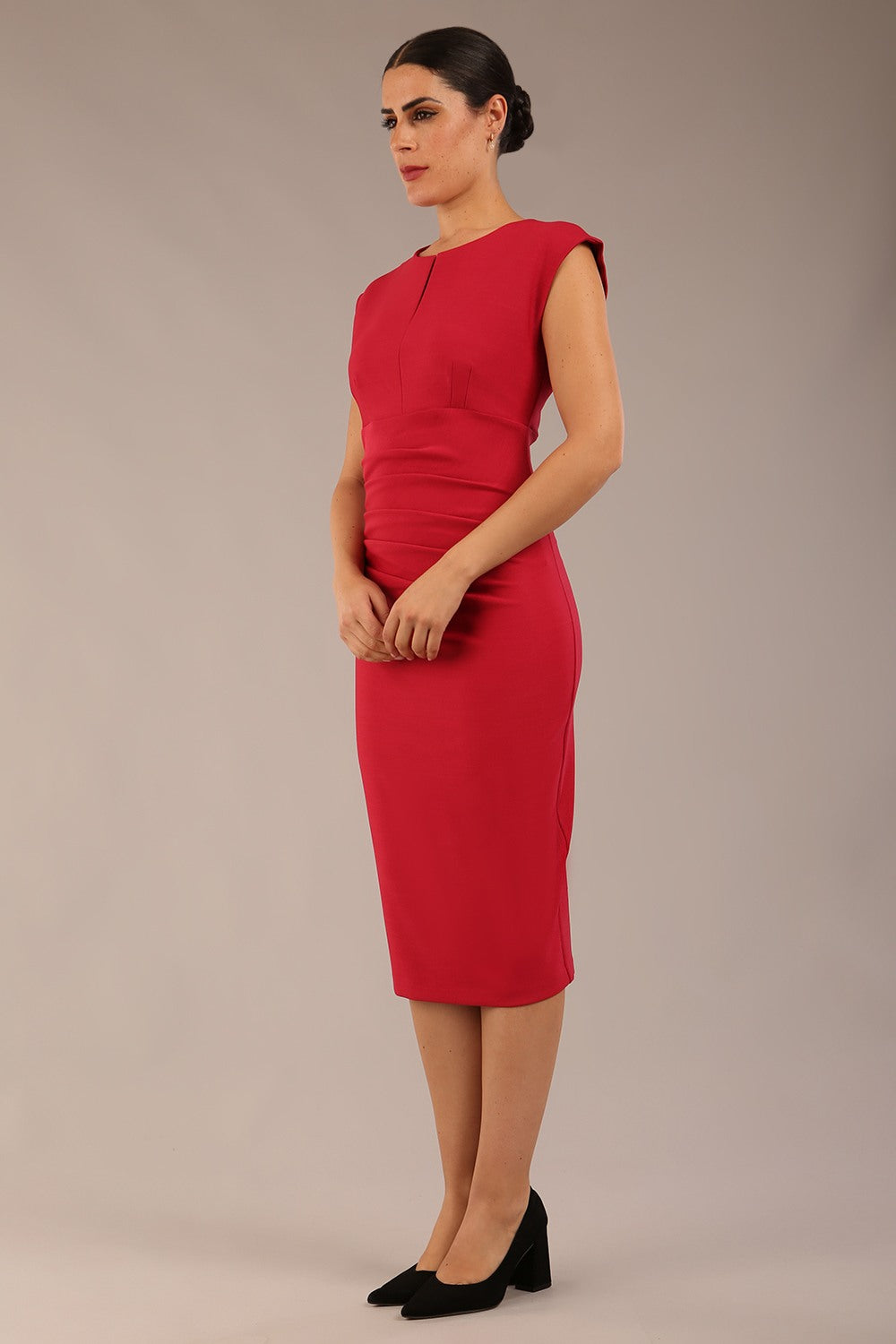 brunette model is wearing a diva catwalk seed Fitzrovia sleeveless pencil dress with round neckline and v-slit and knee length in crimson pink colour front image
