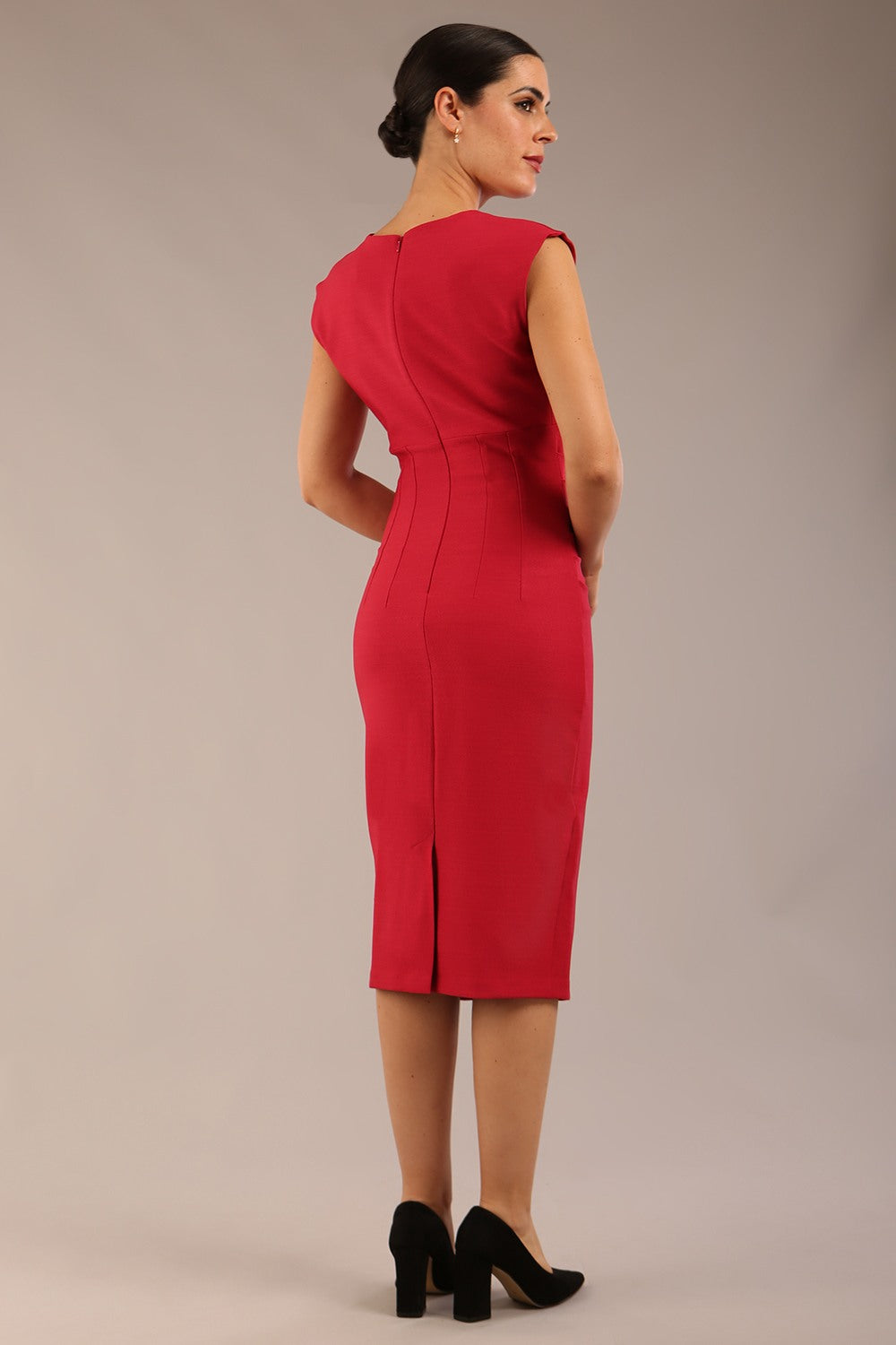 brunette model is wearing a diva catwalk seed Fitzrovia sleeveless pencil dress with round neckline and v-slit and knee length in crimson pink colour front image