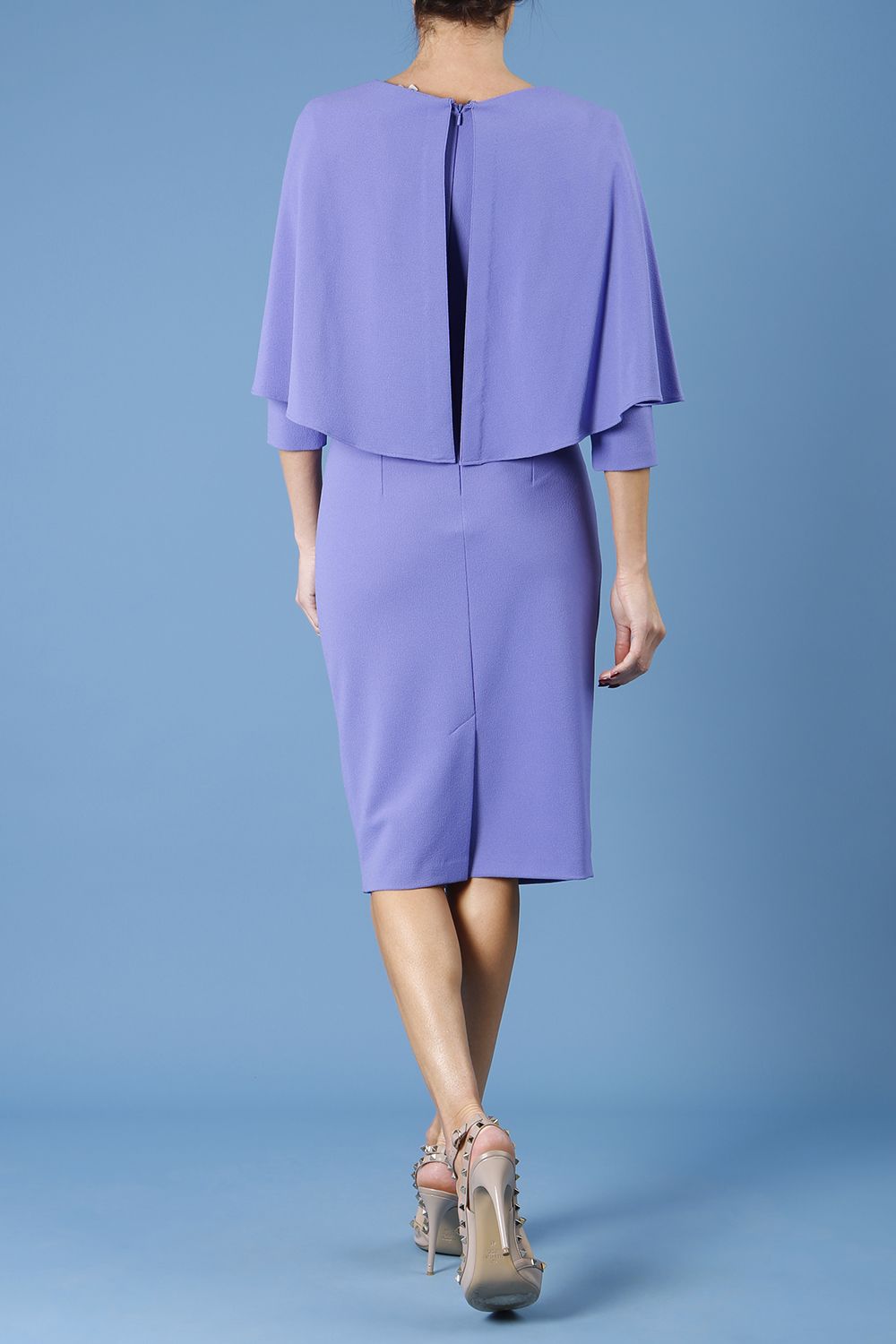 model wearing diva catwalk lizanne pencil-skirt dress with an attached wide cape detail and 3 4 sleeves in colour fusion indigo front