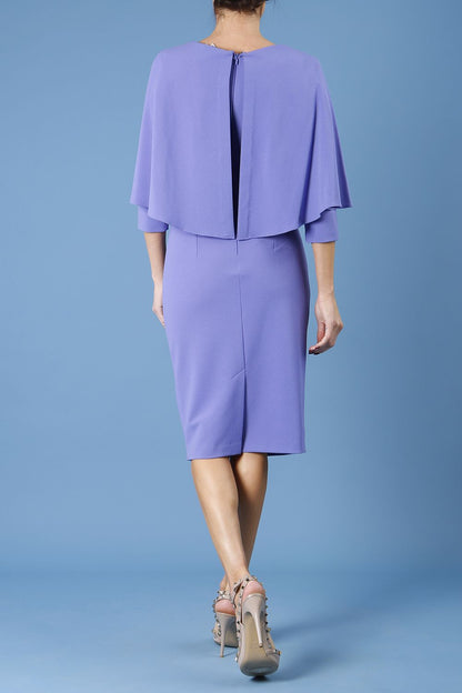 model wearing diva catwalk lizanne pencil-skirt dress with an attached wide cape detail and 3 4 sleeves in colour fusion indigo front