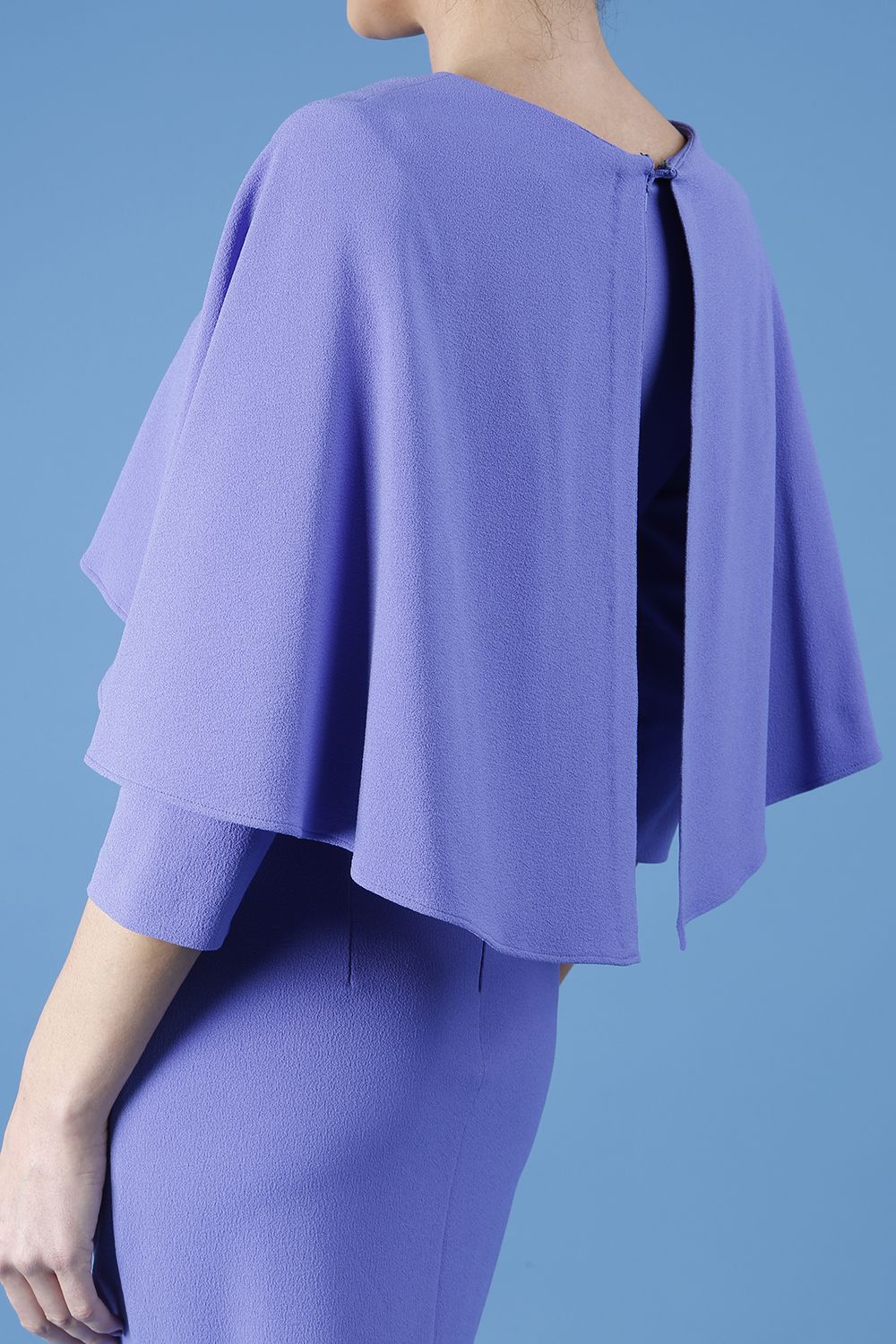model wearing diva catwalk lizanne pencil-skirt dress with an attached wide cape detail and 3 4 sleeves in colour fusion indigo front