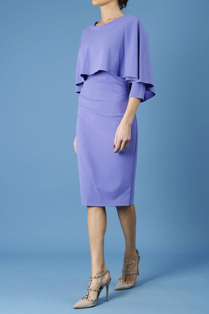 model wearing diva catwalk lizanne pencil-skirt dress with an attached wide cape detail and 3 4 sleeves in colour fusion indigo front