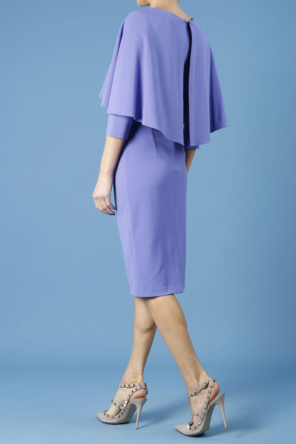 model wearing diva catwalk lizanne pencil-skirt dress with an attached wide cape detail and 3 4 sleeves in colour fusion indigo front