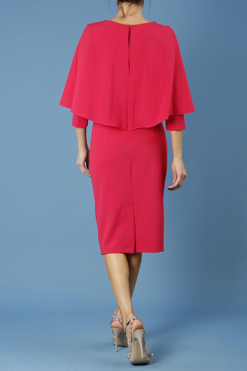 model wearing diva catwalk lizanne pencil-skirt dress with an attached wide cape detail and 3 4 sleeves in colour honeysuckle pink back