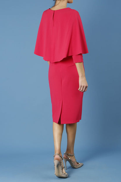 model wearing diva catwalk lizanne pencil-skirt dress with an attached wide cape detail and 3 4 sleeves in colour honeysuckle pink back