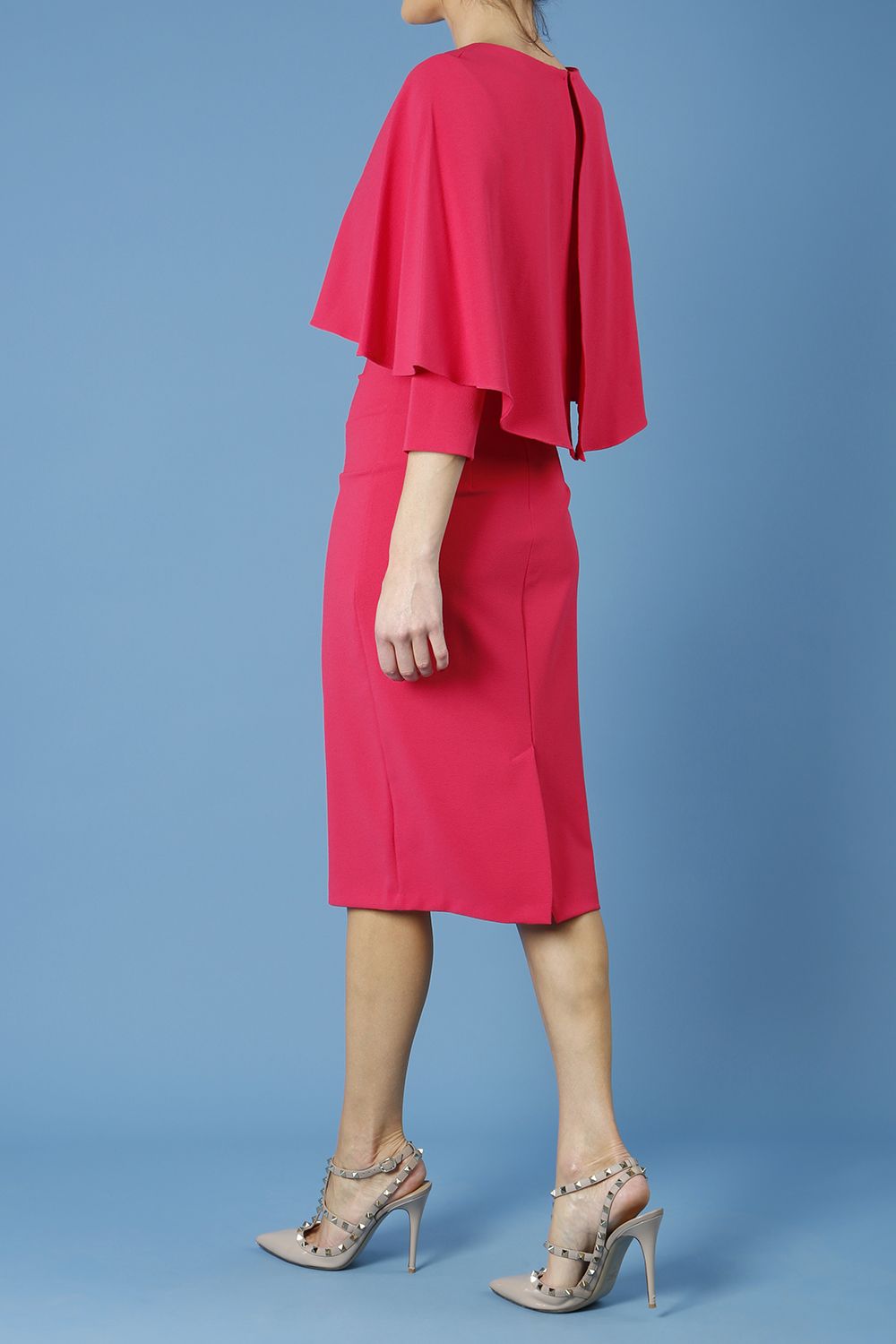 model wearing diva catwalk lizanne pencil-skirt dress with an attached wide cape detail and 3 4 sleeves in colour honeysuckle pink back