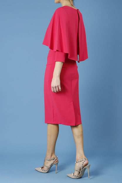 model wearing diva catwalk lizanne pencil-skirt dress with an attached wide cape detail and 3 4 sleeves in colour honeysuckle pink back