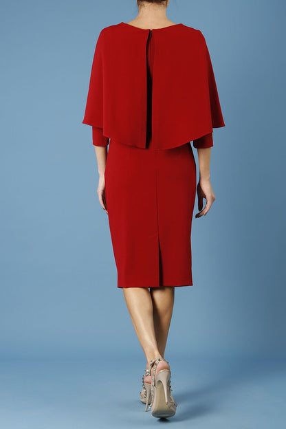 model wearing diva catwalk lizanne pencil-skirt dress with an attached wide cape detail and 3 4 sleeves in colour rosewood red front