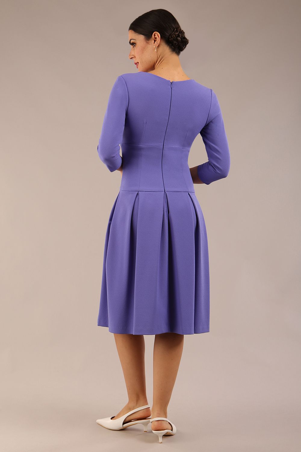 brunette model wearing a diva catwalk malinda swing dress with 3/4 sleeves and knee length and wide waistband in ripple crepe fabric in fusion indigo colour back side image