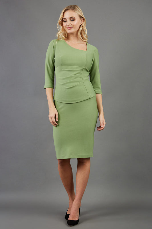 blonde model is wearing diva catwalk pencil skirt in aspen green front