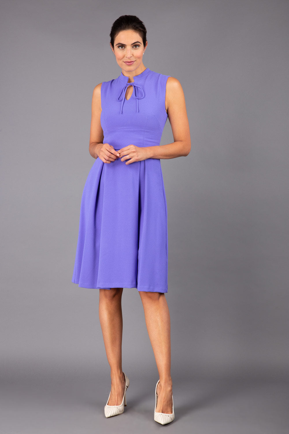 brunette model wearing diva catwalk oceana a-line swing skirt sleeveless dress with funnel neckline and tie detail in lilac purple front