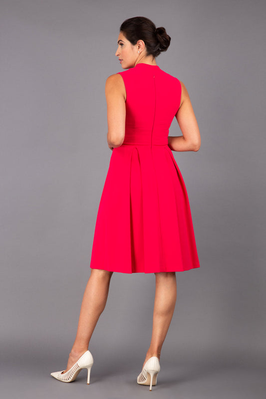 brunette model wearing diva catwalk oceana a-line swing skirt sleeveless dress with funnel neckline and tie detail in pink back