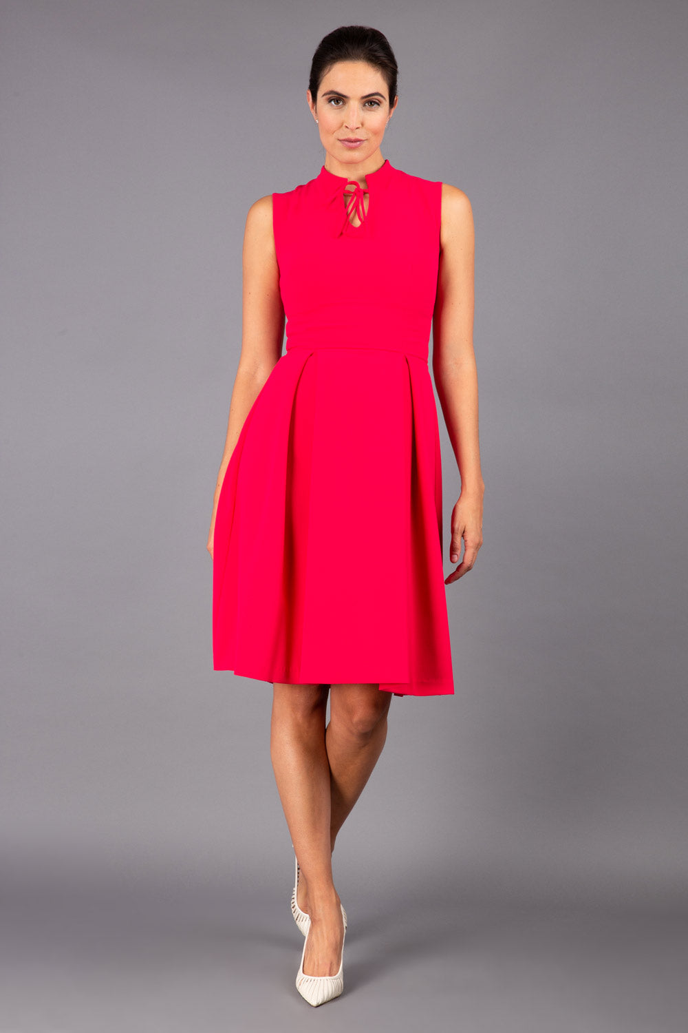 brunette model wearing diva catwalk oceana a-line swing skirt sleeveless dress with funnel neckline and tie detail in pink back