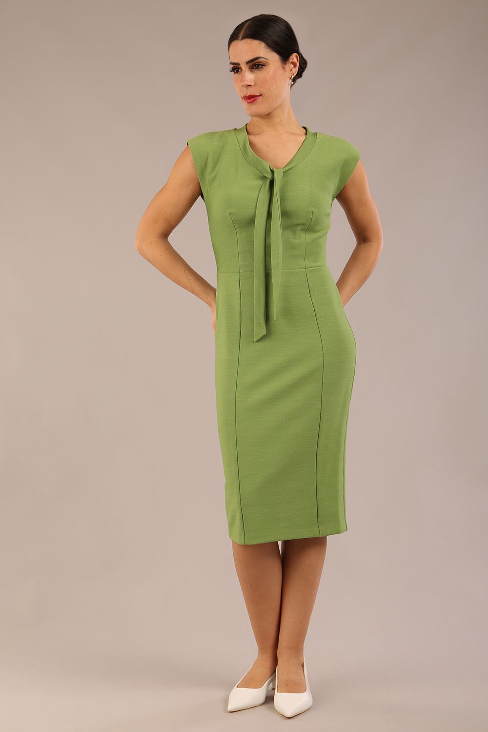 blond model wearing a diva catwalk seed lucca tie detail cap sleeves pencil dress in citrus green colour front image