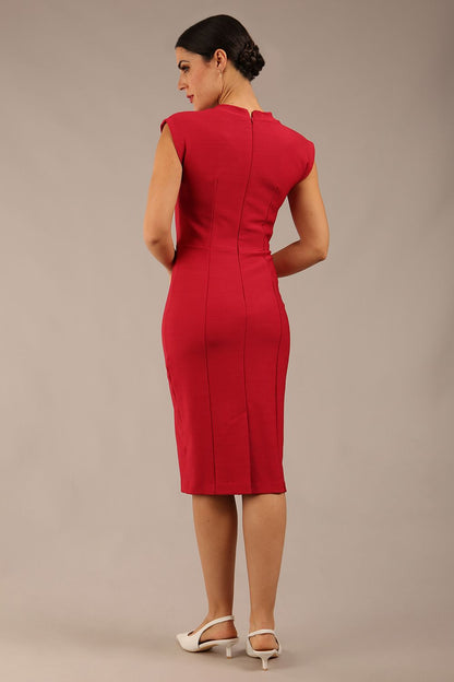 brunette model wearing a diva catwalk seed lucca tie detail cap sleeves pencil dress in crimson pink colour front image