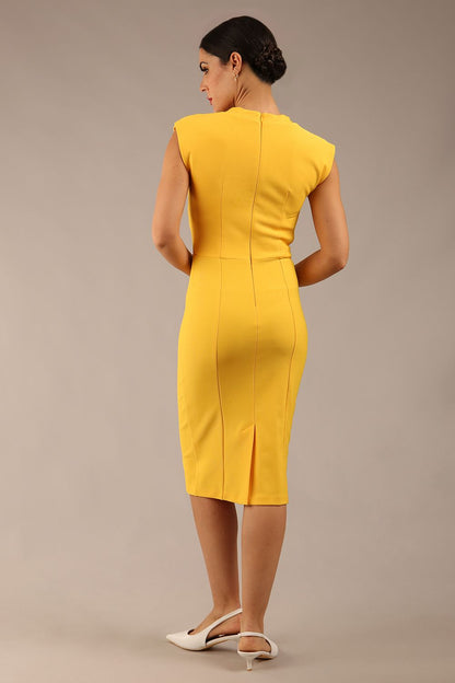 brunette model wearing a diva catwalk seed lucca tie detail cap sleeves pencil dress in daffodil yellow colour front image