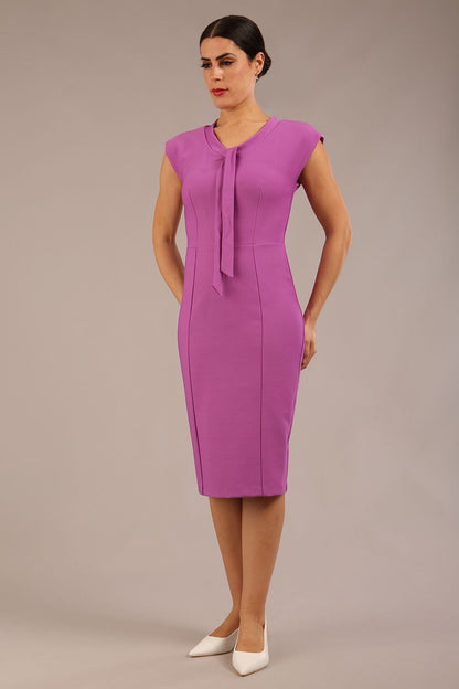 brunette model wearing a diva catwalk seed lucca tie detail cap sleeves pencil dress in magenta mist colour front image