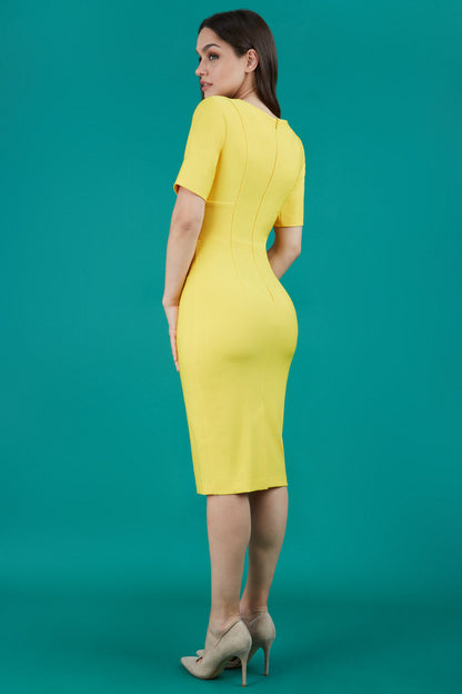 model is wearing diva catwalk seed barton short sleeve pencil dress with v-neck in daffodil yellow front 