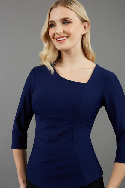 blonde model is wearing diva catwalk courtney sleeved top in colour navy front paired with black skirt