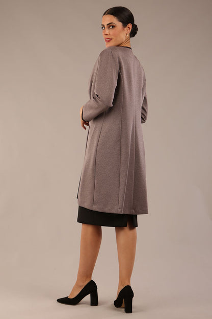 Model wearing the Diva Alverstone Coat in Mist Pink and black front image    