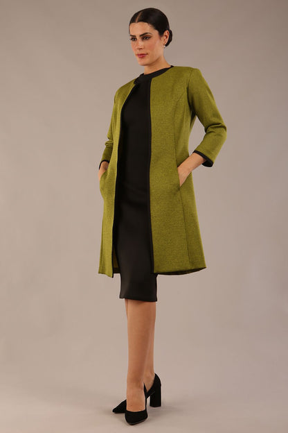 Model wearing the Diva Alverstone Coat in Amber green and black front image    