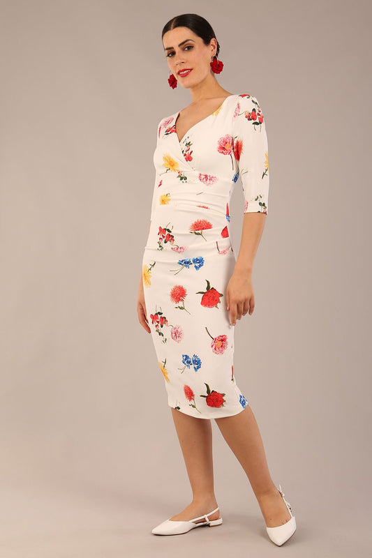 brunette model is wearing a diva catwalk Cynthia Floral Print Dress sleeved crossover v neckline knee length in Buttercup Print back image