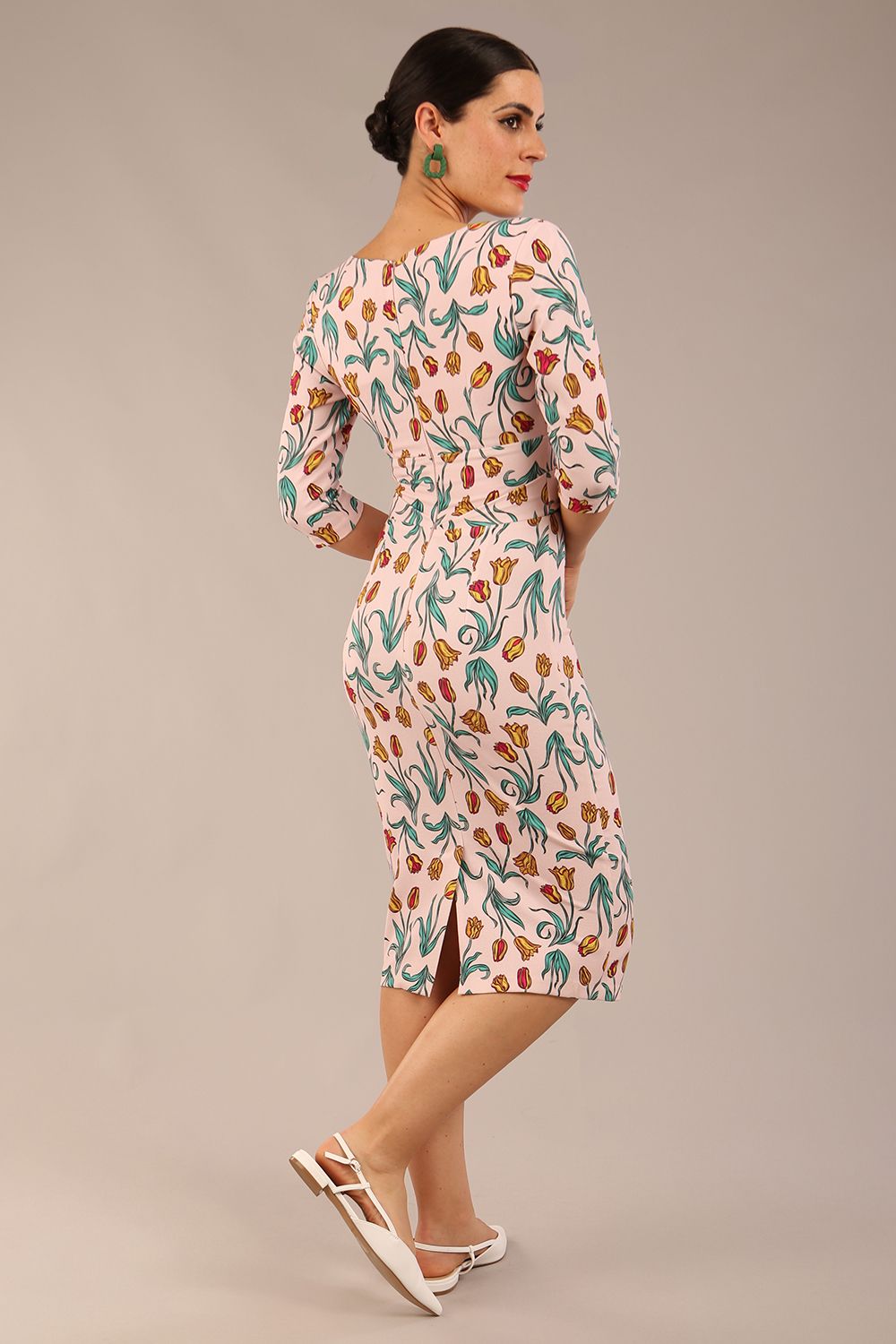 brunette model is wearing a diva catwalk Cynthia Floral Print Dress sleeved crossover v neckline knee length in Linear Tulip Print back image