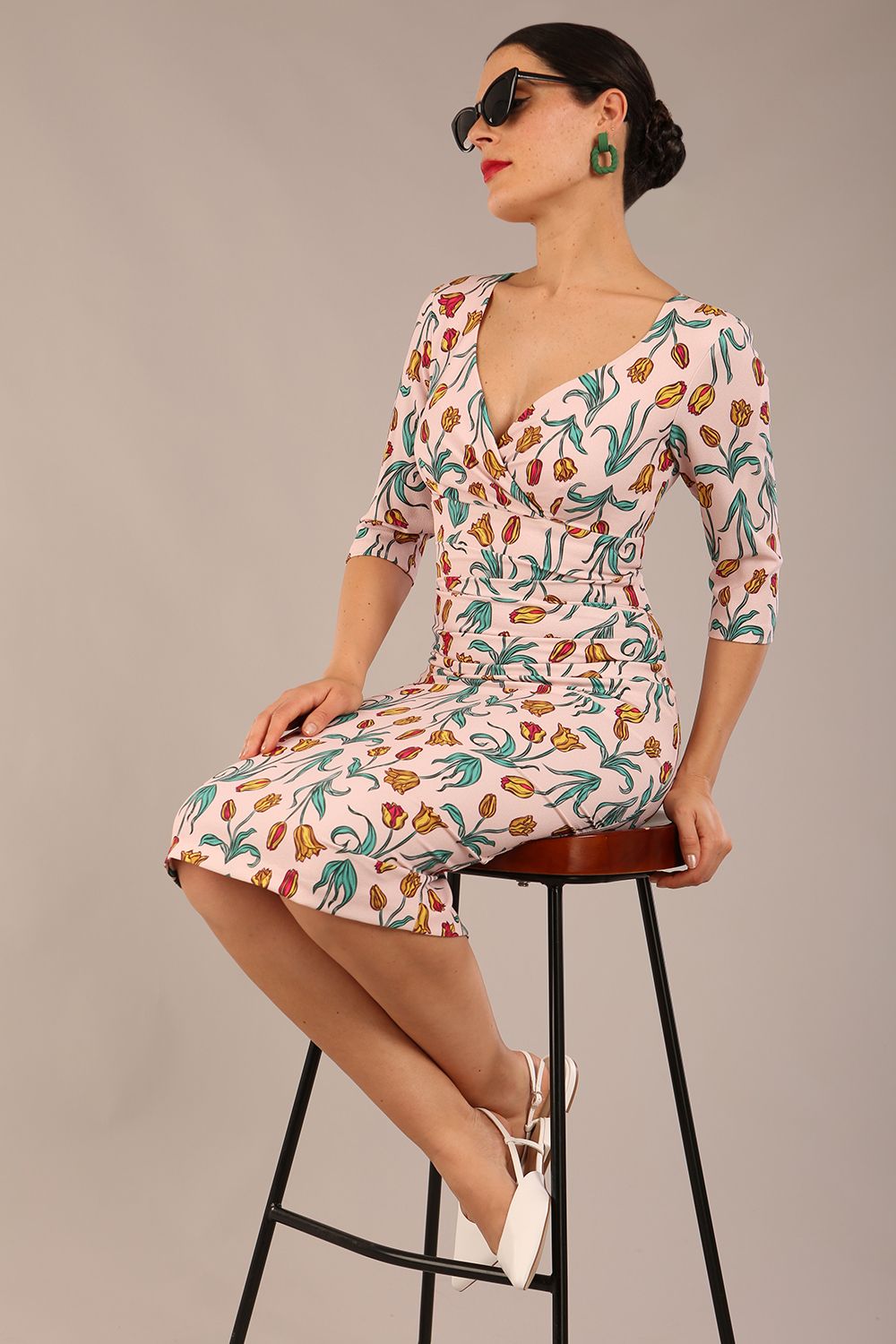 brunette model is wearing a diva catwalk Cynthia Floral Print Dress sleeved crossover v neckline knee length in Linear Tulip Print back image