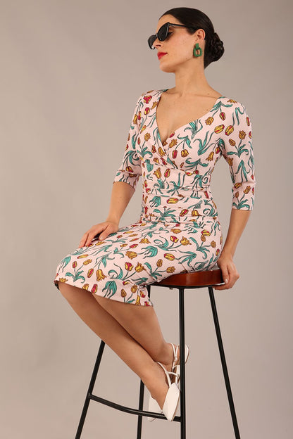 brunette model is wearing a diva catwalk Cynthia Floral Print Dress sleeved crossover v neckline knee length in Linear Tulip Print back image