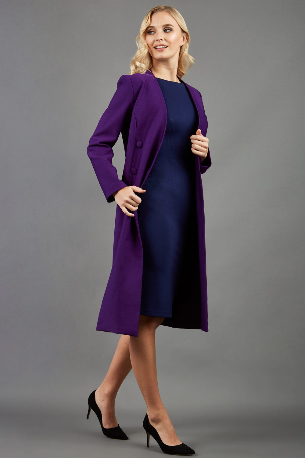 blonde model wearing the Diva Silverstone Coat with V neckline in imperial purple front image
