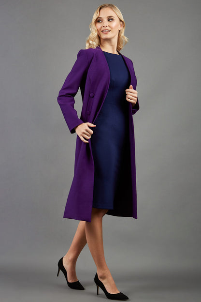 blonde model wearing the Diva Silverstone Coat with V neckline in imperial purple front image