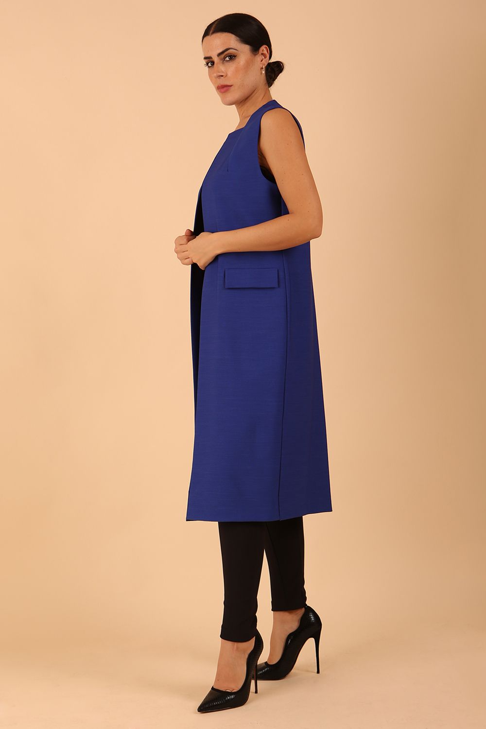 model wearing a divacatwalk Seed Harvard Sleeveless Coat midi length in Monaco Blue colour front