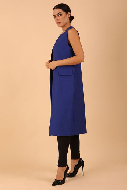 model wearing a divacatwalk Seed Harvard Sleeveless Coat midi length in Monaco Blue colour front