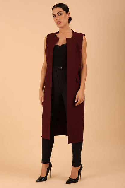 model wearing a divacatwalk Seed Harvard Sleeveless Coat midi length in Port Royale colour front