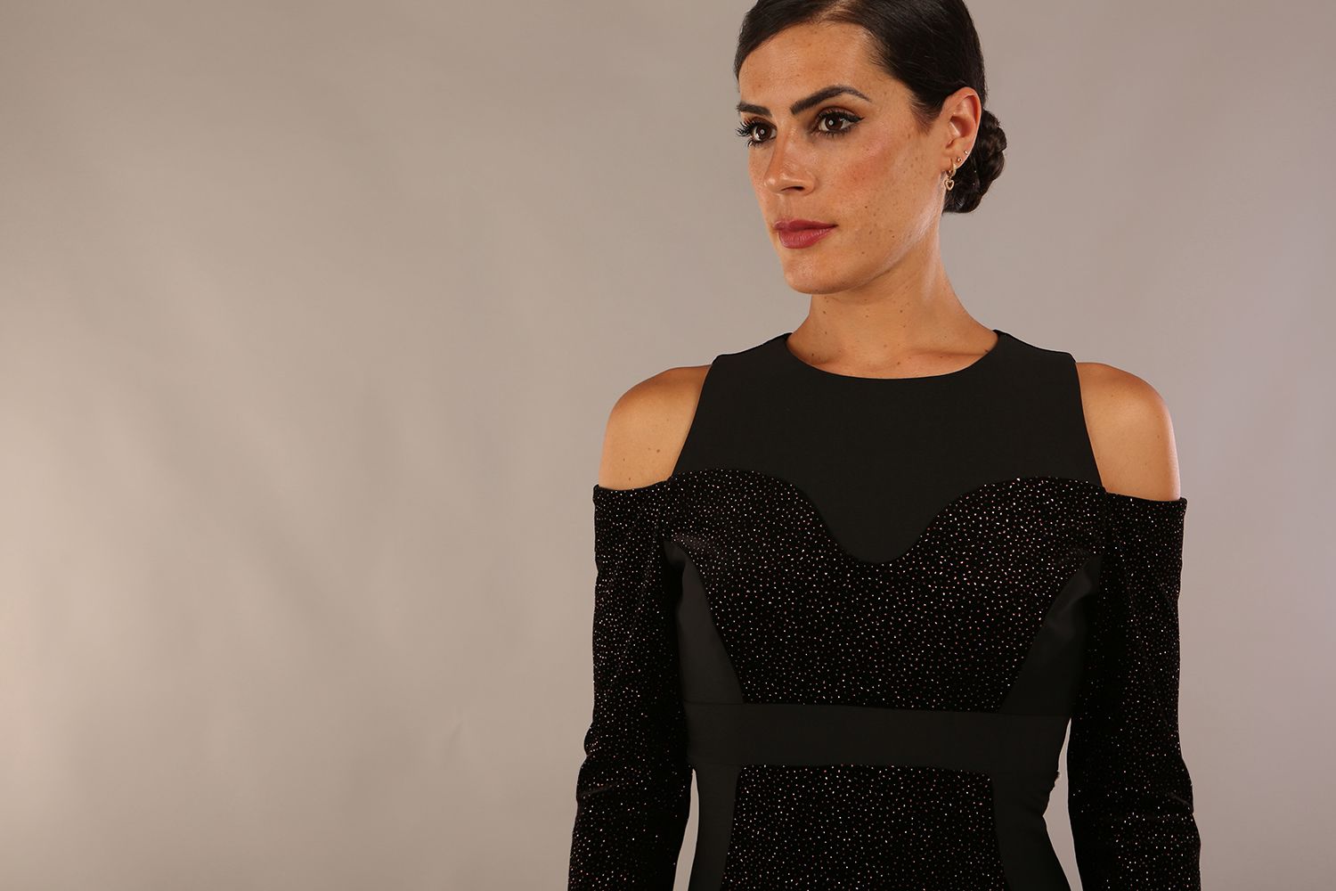 blonde model is wearing diva catwalk partyon glitter pencil dress with cold shoulder in black front