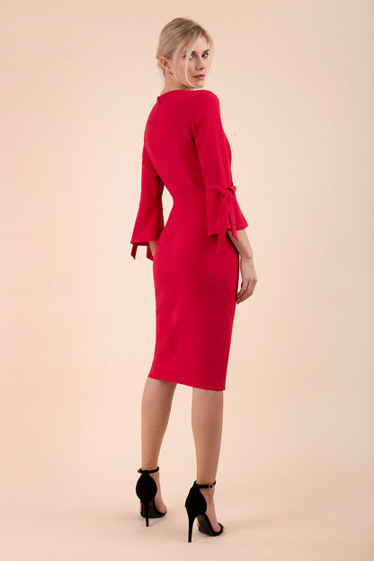 blonde model wearing diva catwalk zoe 3 4 sleeve formal dress with a split rounded neckline and split on skirt in ruby red colour front