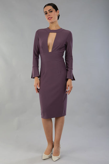 model is wearing diva catwalk fifi pencil skirt dress with three quarter flute sleeve and rounded neckline with a cut out at the front in mauve