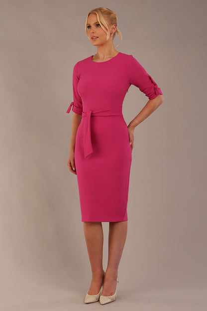 model wearing diva catwalk tryst pencil pink dress with sleeves and belt detail at the front with rounded neckline front (Fuchsia Pink)