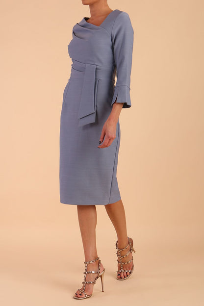 Model wearing diva catwalk Seed Orla Asymmetric Pencil Dress in Steel Blue front side