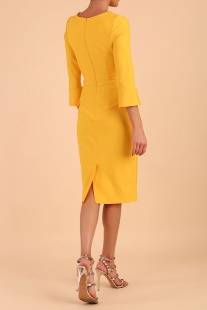 Model wearing diva catwalk Seed Orla Asymmetric Pencil Dress in Saffron Yellow front