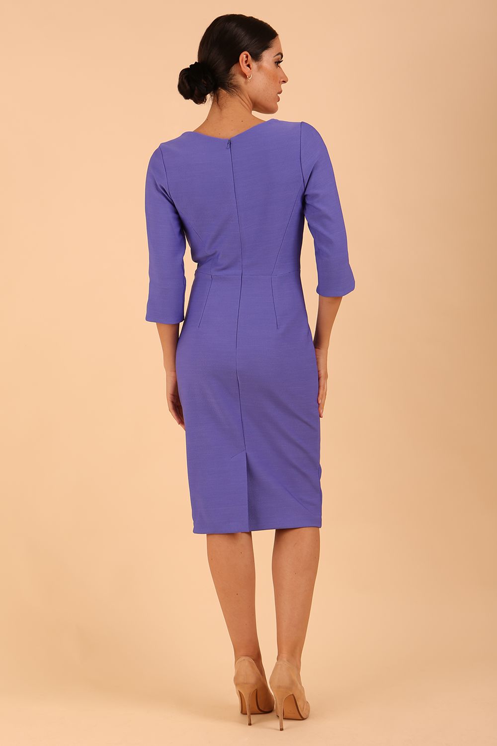 model wearing seed couture zara pencil skirt dress in dawn indigo with asymmetric neckline with sleeves front