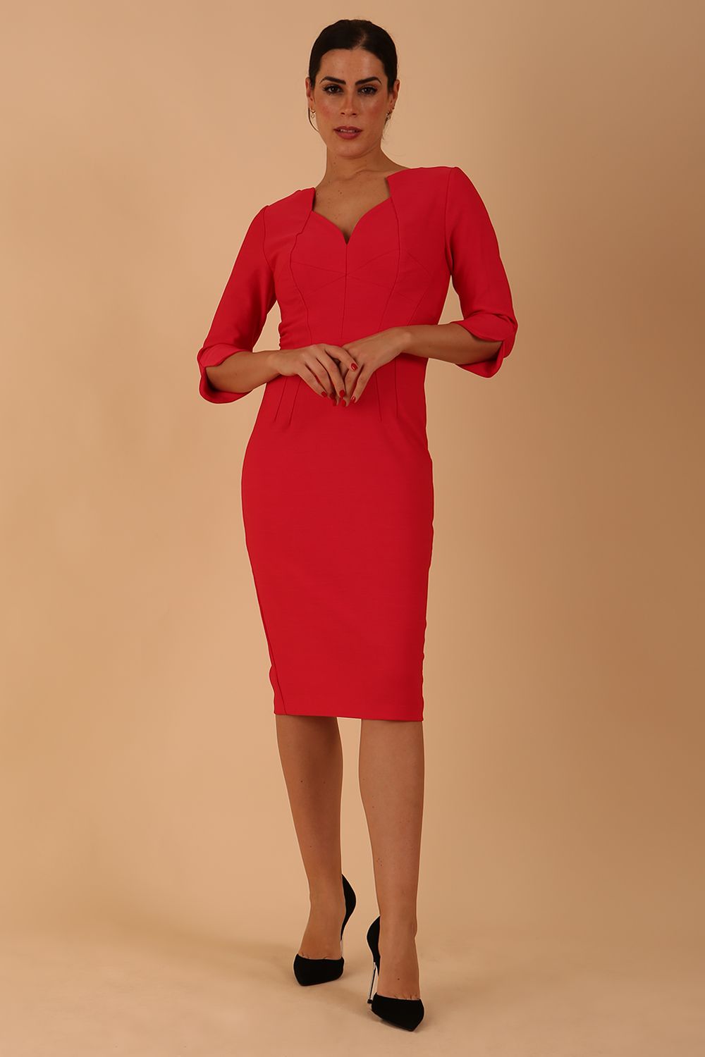 model wearing seed couture zara pencil skirt dress with asymmetric neckline with sleeves in opera pink colour