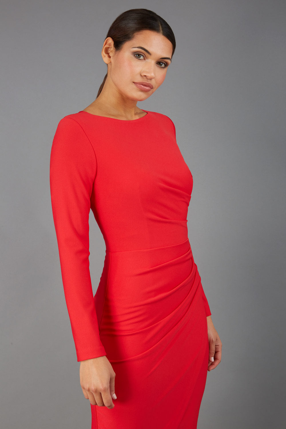 brunette model wearing diva catwalk pencil skirt dress sleeved with  pleating on side in electric red colour front (Electric Red)