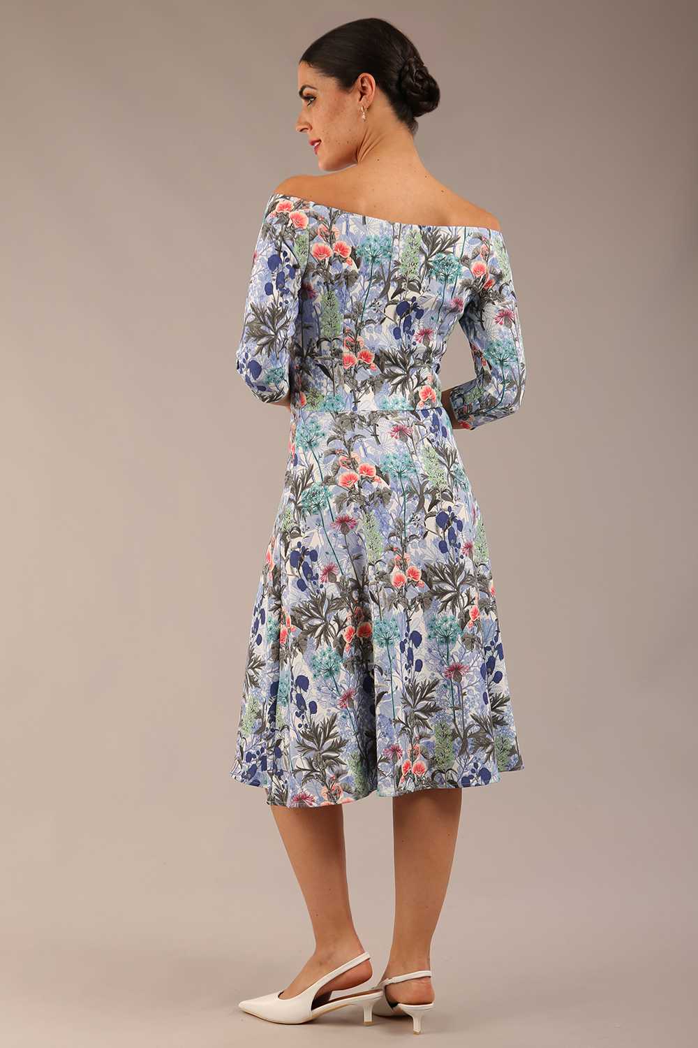 brunette model is wearing a diva catwalk islay a-line wing print dress off shoulder and knee length in water garden print front image