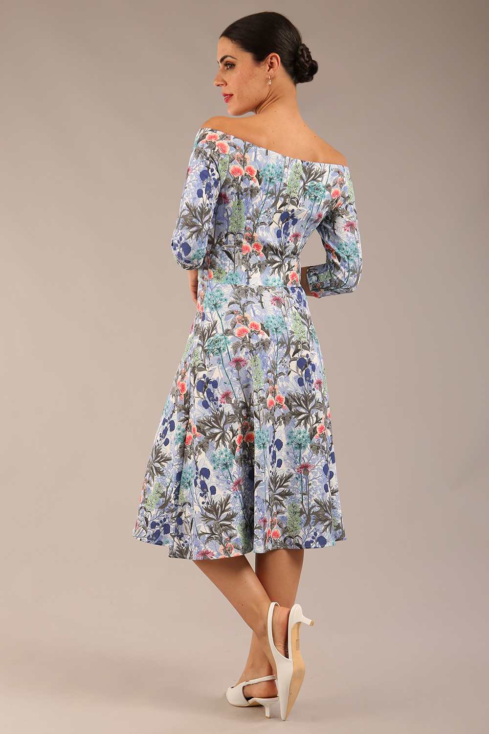 brunette model is wearing a diva catwalk islay a-line wing print dress off shoulder and knee length in water garden print front image