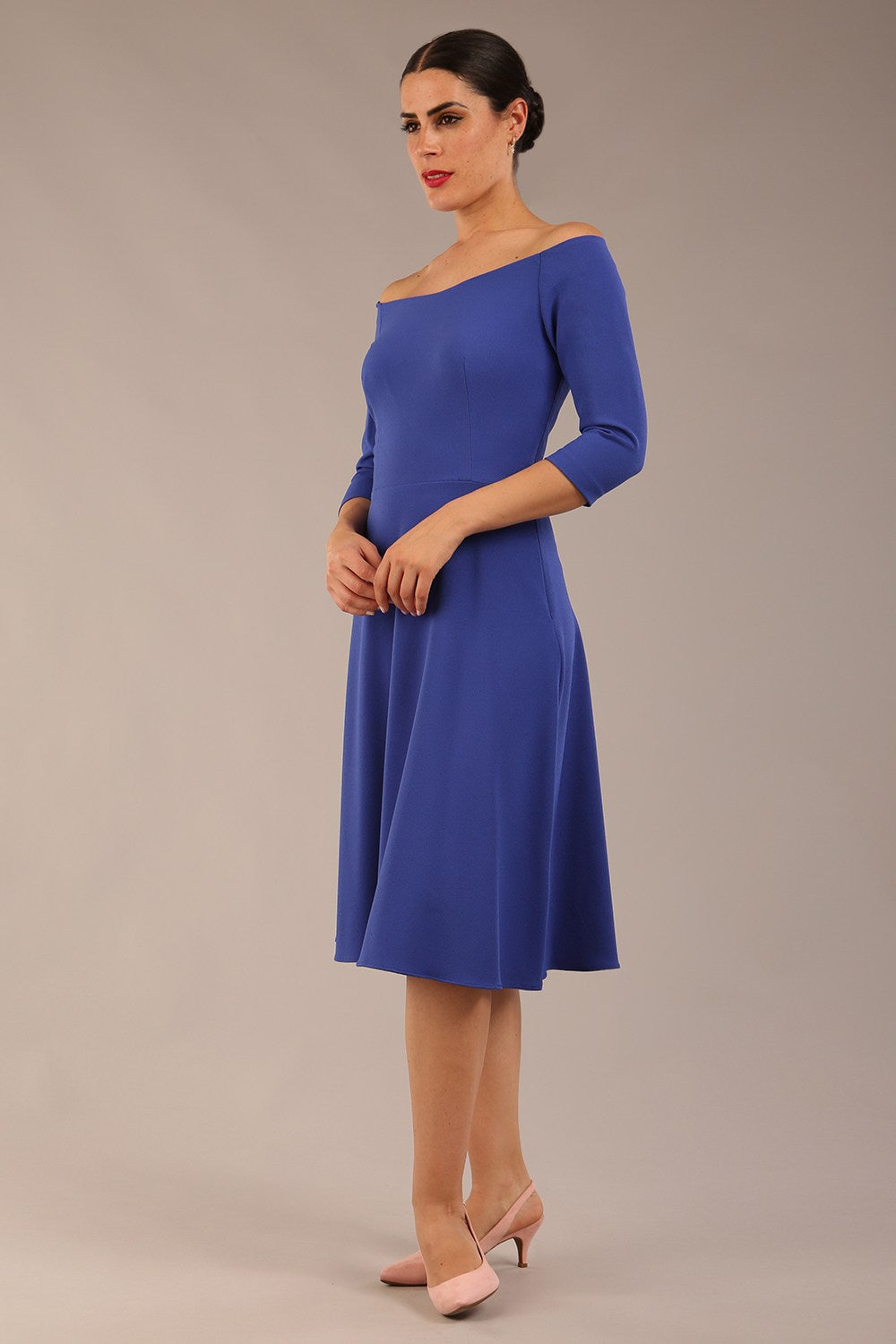 brunette model is wearing diva catwalk off shoulder swing a-line islay dress with sleeves in riviera blue colour front image 