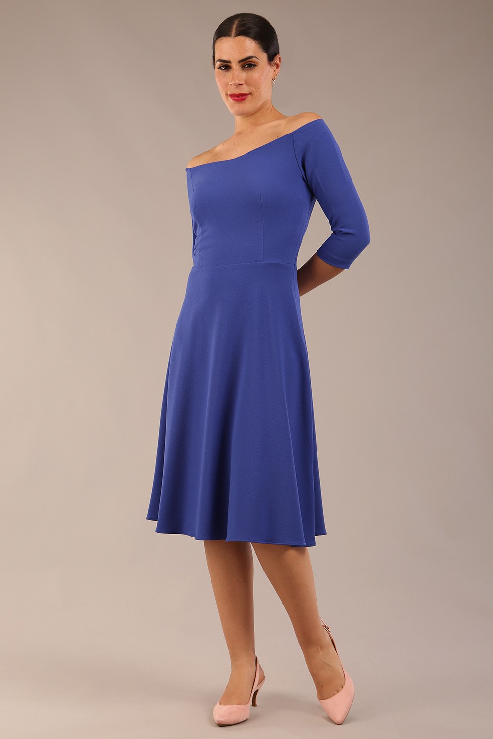 brunette model is wearing diva catwalk off shoulder swing a-line islay dress with sleeves in riviera blue colour front image 