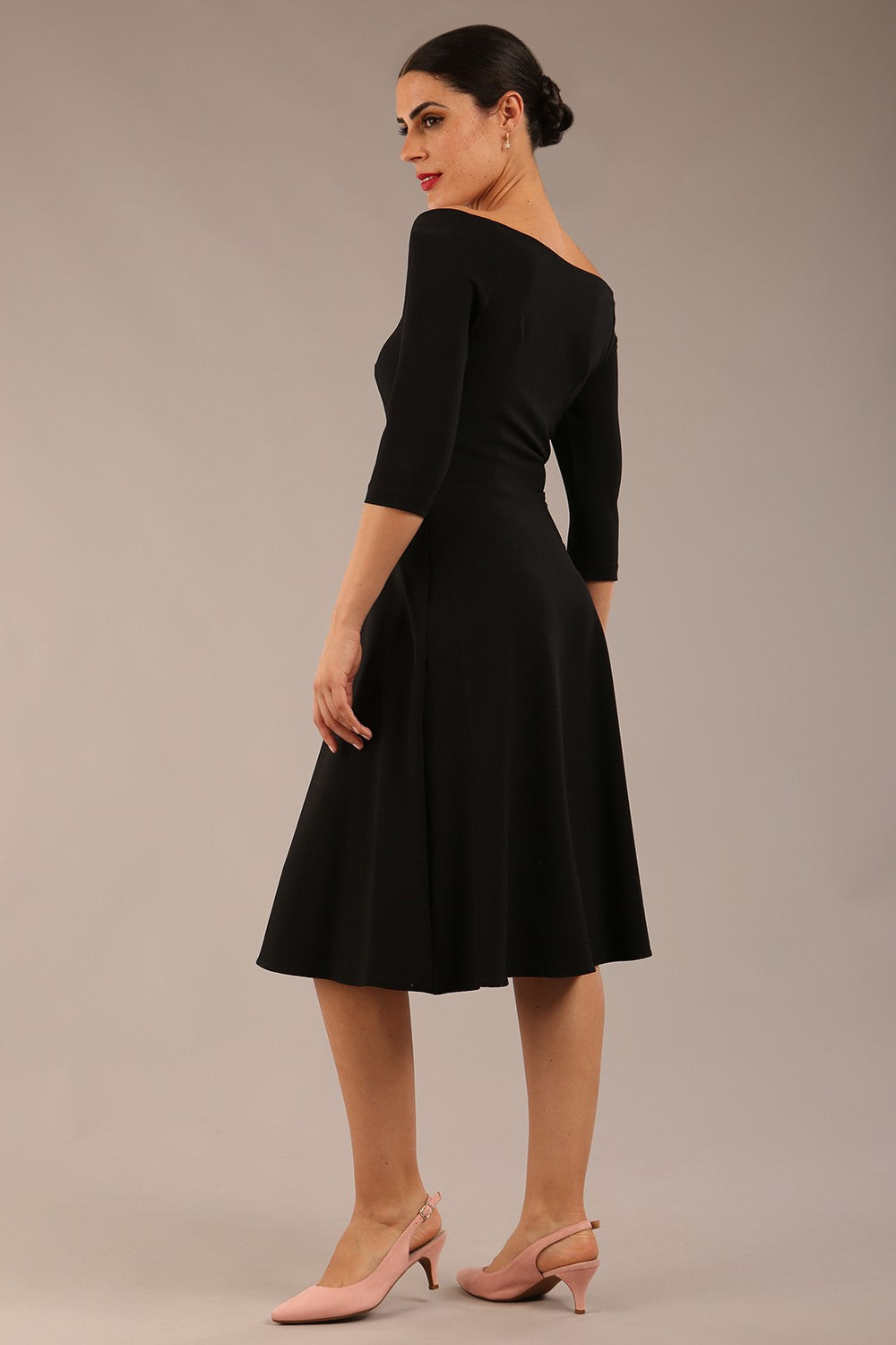 brunette model is wearing diva catwalk off shoulder swing a-line islay dress with sleeves in black colour front image 