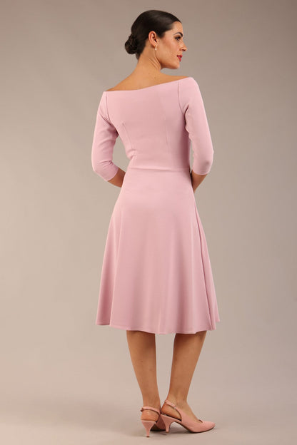 brunette model is wearing diva catwalk off shoulder swing a-line islay dress with sleeves in dawn pink colour front image with sunglasses