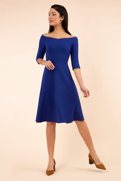brunette model is wearing diva catwalk off shoulder swing a-line islay dress with sleeves in oxford blue colour front image 